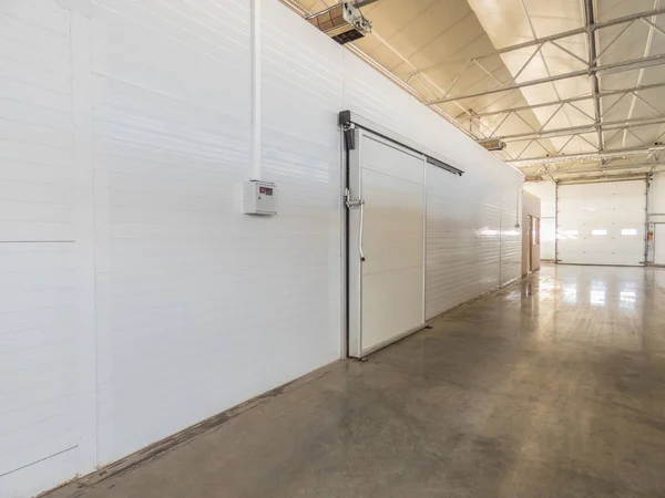 large freezer storage in the factory. closed door from warehouse