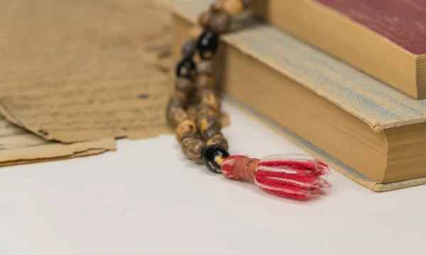 Muslim prayer beads with Quran and with sheets with ancient Arabic scripts. Islamic and Muslim concepts