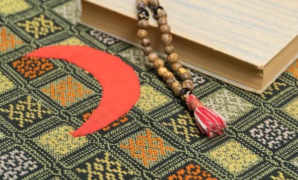 Muslim prayer beads and Quran on the prayer Mat. Islamic and Muslim concepts