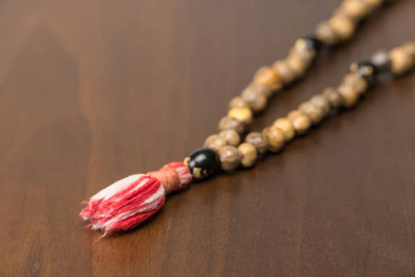 Muslim prayer beads isolated on a wooden background. Islamic and Muslim concepts