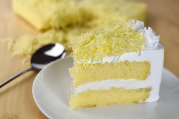 Piece of cake with whip cream and grated cheese topping — Stock Photo, Image