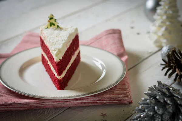 Gâteau de velours rouge avec décoration crème blanche sur table blanche — Photo