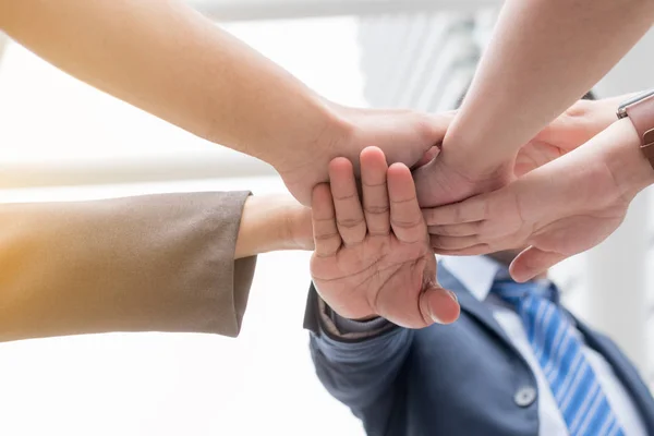 business team work concept : business people hold hand together