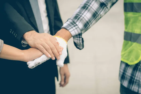 business team work concept : business people hold hand together