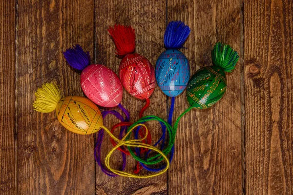 Ukrainian colored Easter eggs with ornaments on a wooden background — Stock Photo, Image