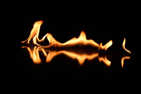 Flames on a black background with mirror reflection — Stock Photo, Image