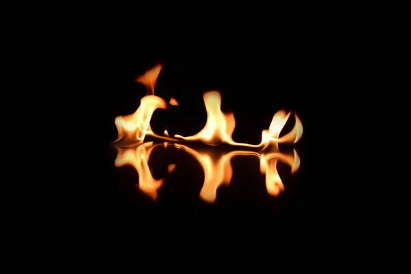 Flames on a black background with mirror reflection — Stock Photo, Image