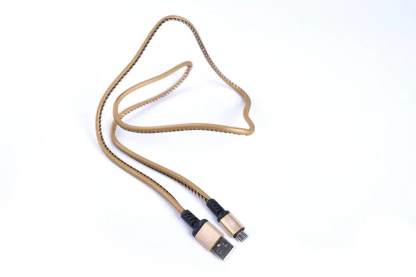 Folded USB lightning charging smartphone golden cable isolated over the white background — 스톡 사진