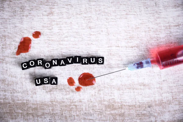 Concept coronavirus,MERS-Cov middle East respiratory syndrome Covid 19.Coronavirus originating in Wuhan, China.Inscription .Syringe and blood on wooden table. — Stock Photo, Image