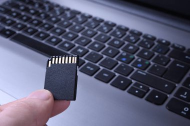 El bilgisayarı flaş bellek, Micro Sd hafıza kartı adaptörü tahta arka planda. Kapat.