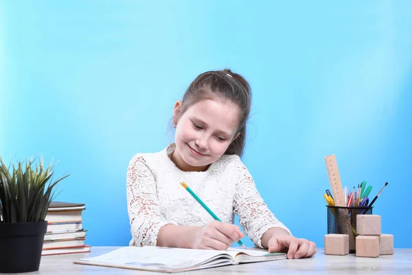 Back to school .Happy cute industrious child is sitting at a desk indoors. Kid is learning in class.quarantine.Kid is learning in home