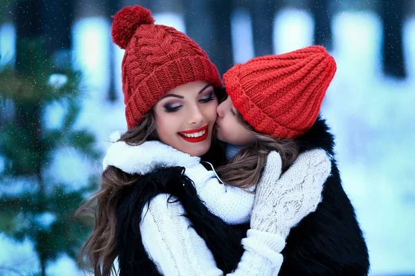 Madre con su hija besándose al aire libre en invierno naturaleza — Foto de Stock