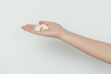 El kapsül beyaz zemin üzerine veriyor.