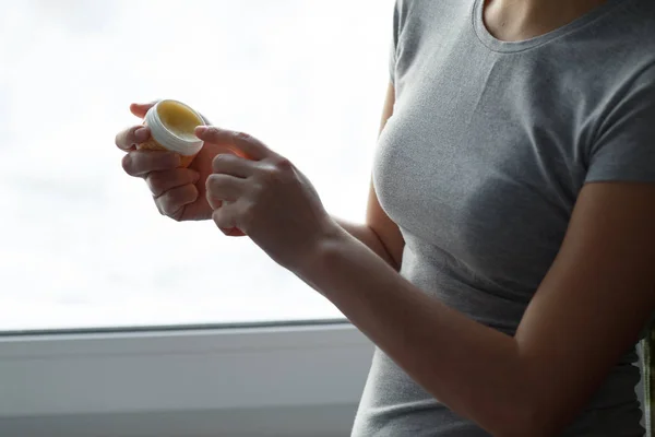 Female applying balm moisturizing balsam. — Stock Photo, Image