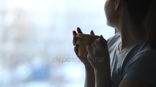 Young Woman Enjoying her morning coffee or tea, Looking Out the Window — Stock Video