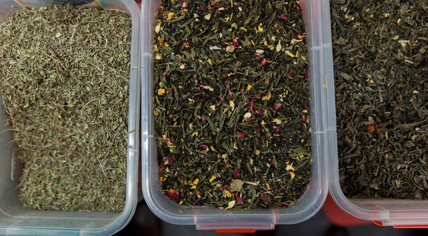 Dry green tea with fruit and flower petals on fair