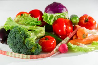 Sebze ve ölçüm bandı, beyaz arka plan üzerinde izole natürmort