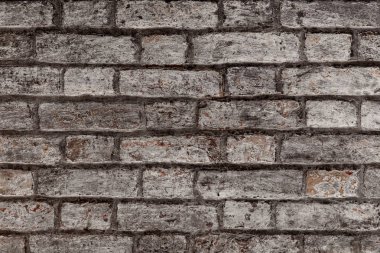 Soyulmuş alçılı eski, eski, kirli tuğla duvarın arka planı