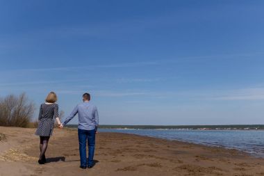 Birkaç yürüme el ele kumsalda tam uzunlukta dikiz