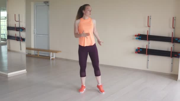 Young girl dancing zumba in gym or studio — Stock Video