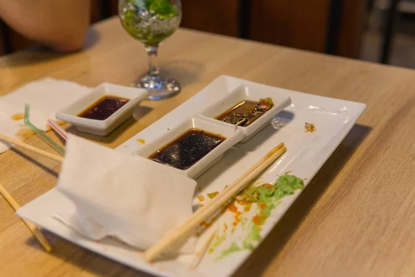 Empty dirty plate of sushi on table in cafe. — Stock Photo, Image