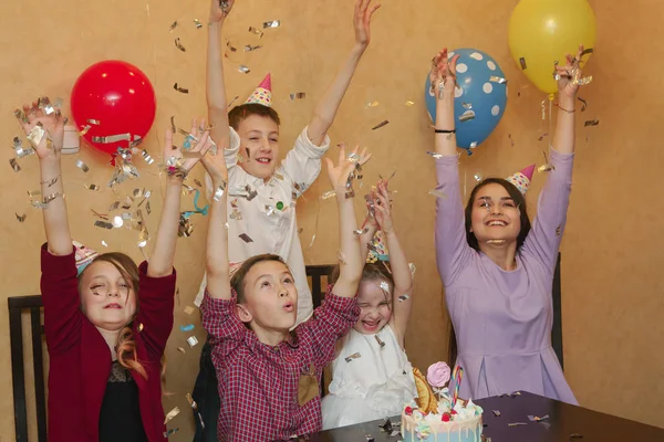 Дети бросают конфетти на детскую вечеринку. дети веселятся вместе на семейном празднике . — стоковое фото