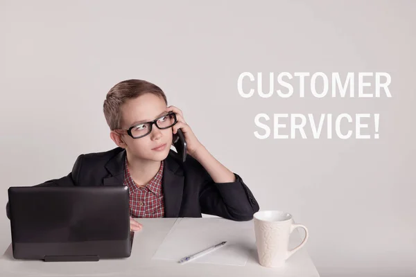 Cute little boy in a suit talking on the phone — Stock Photo, Image