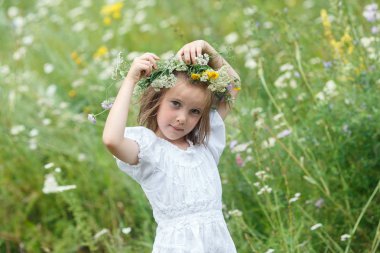 Çelenk çimenlerin üzerinde oturan kır çiçekleri gelen kadın