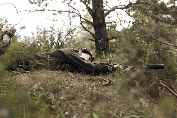 Young boy in camouflage with a gun, lasertag