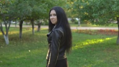 genç güzel kız yürüyüş ve güneşli yaz park arka plan üzerinde etrafında döner