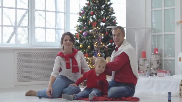 Familia feliz con confeti en el fondo del árbol de Navidad con regalos . — Vídeos de Stock