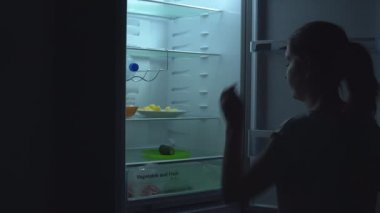 Genç kadın salatalık alır