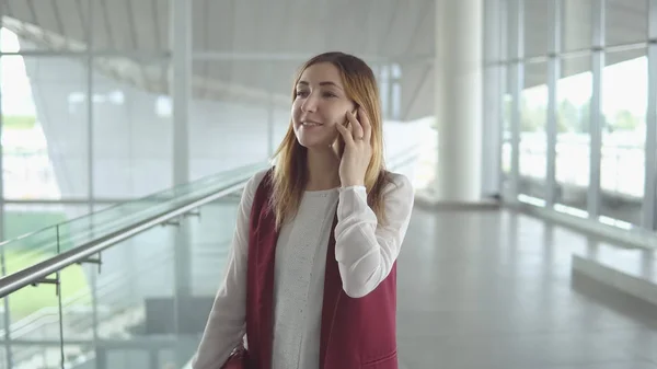 Woman speaks on smartphone while boarding on plane