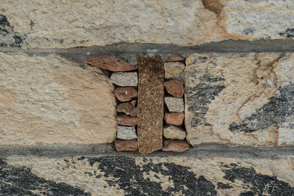 Aged stone, old bricks texture closeup