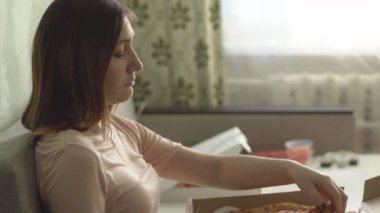Pizza evde koltukta oturan ile yalnız hüzünlü kız ve bir film izliyor