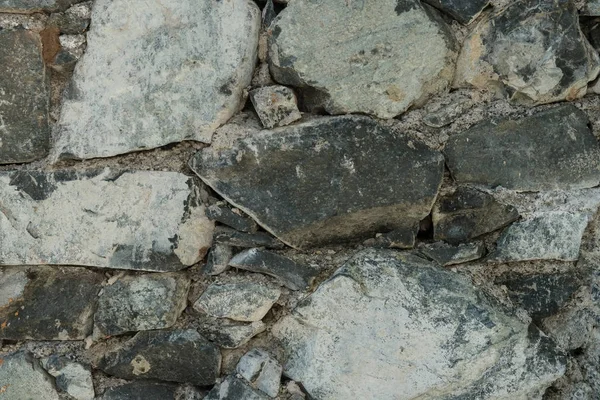 Гранитная текстура, поверхность каменной стены крупным планом — стоковое фото