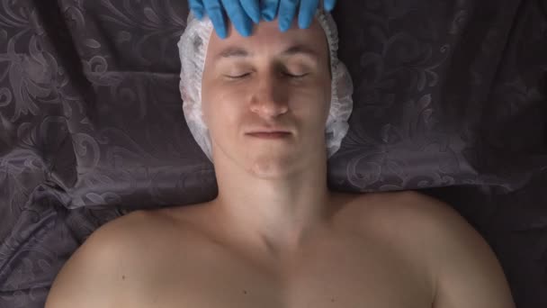 Young man in the spa on facial massage procedure — Stock Video