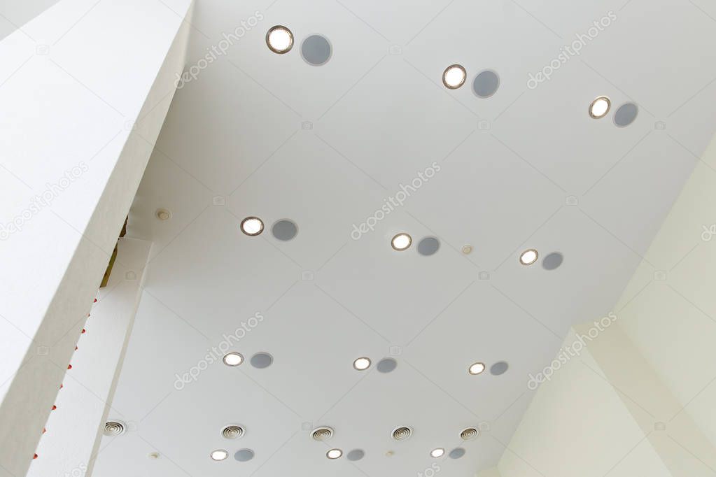 Modern layered ceiling with embedded lights and stretched ceiling inlay
