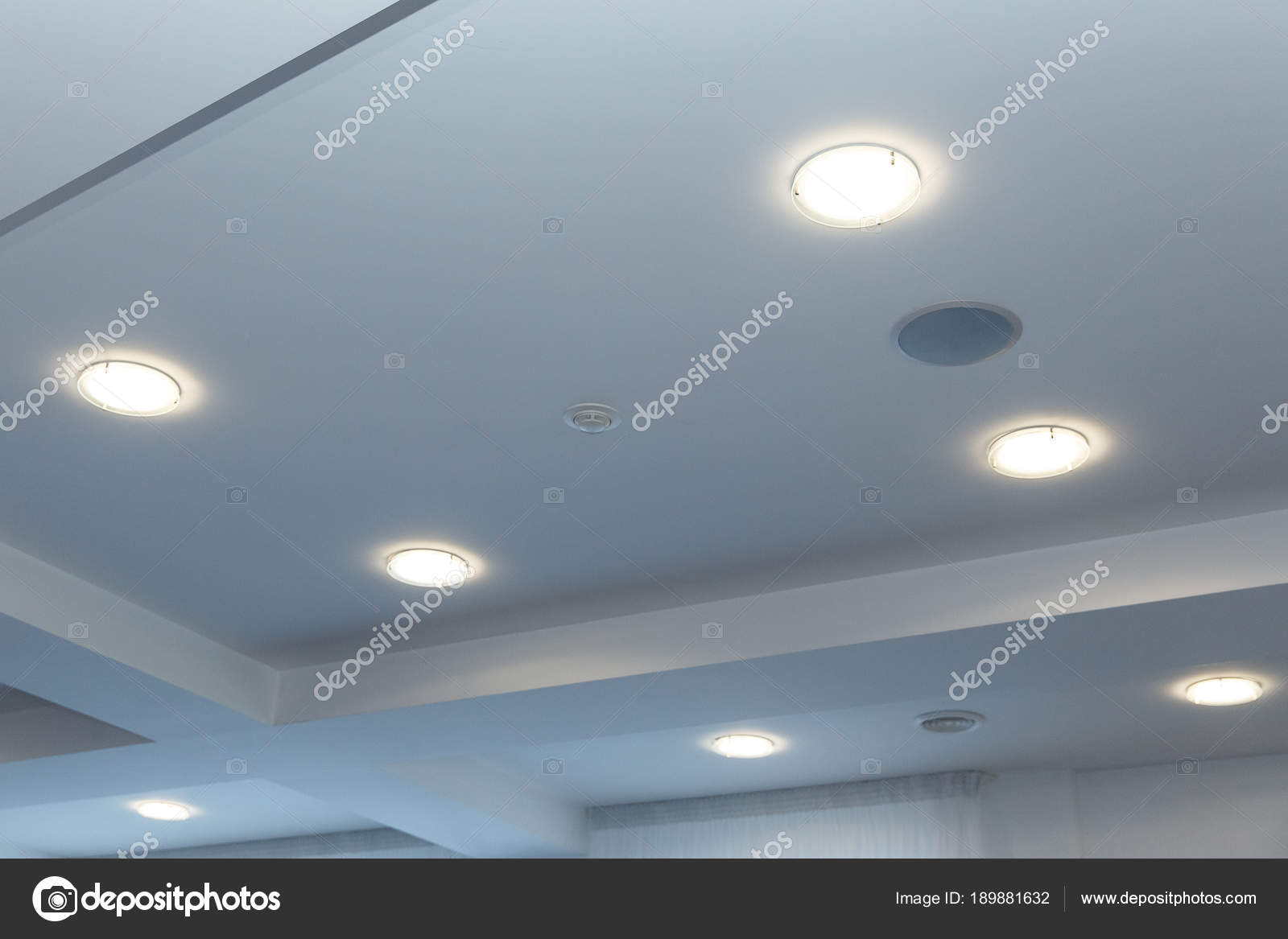 Modern layered ceiling with embedded lights and stretched ceiling inlay