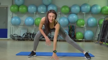 Genç kadın kalçalarda egzersizleri yapıyor. Sağlıklı bir yaşam tarzı kavramı