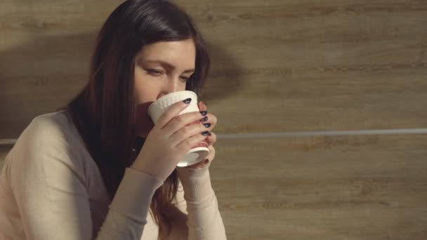 여 자가 즐기는 종이 컵에서 뜨거운 신선한 커피를 마시는 — 비디오