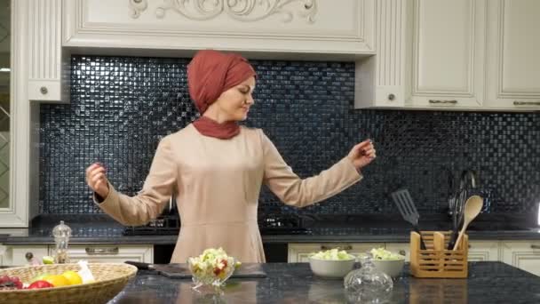Мусульманка танцует восточный танец после приготовления блюд — стоковое видео