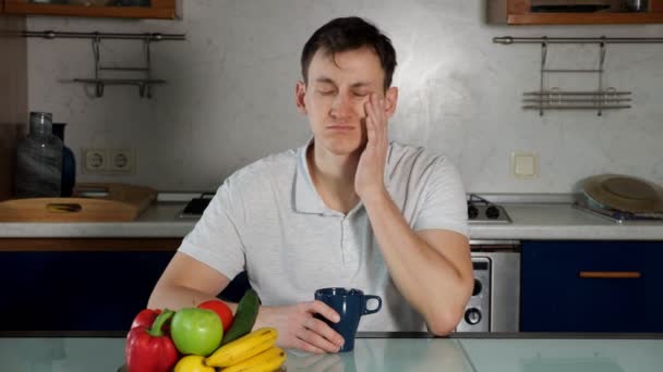 Man sits at dinner table and drinks coffee rubbing eyes — 비디오