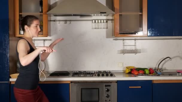 Dama escucha música con auriculares y canta bailando en casa — Vídeos de Stock