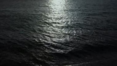 The night sea reflects the bright moonlight