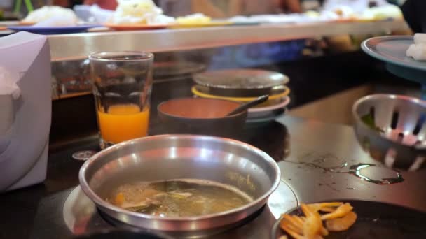 Femme jette calmar dans un bouillon bouillant dans un buffet — Video