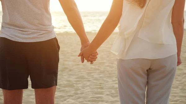 Femme heureuse et les figures de l'homme joignent les mains sur la plage océan vide — Photo