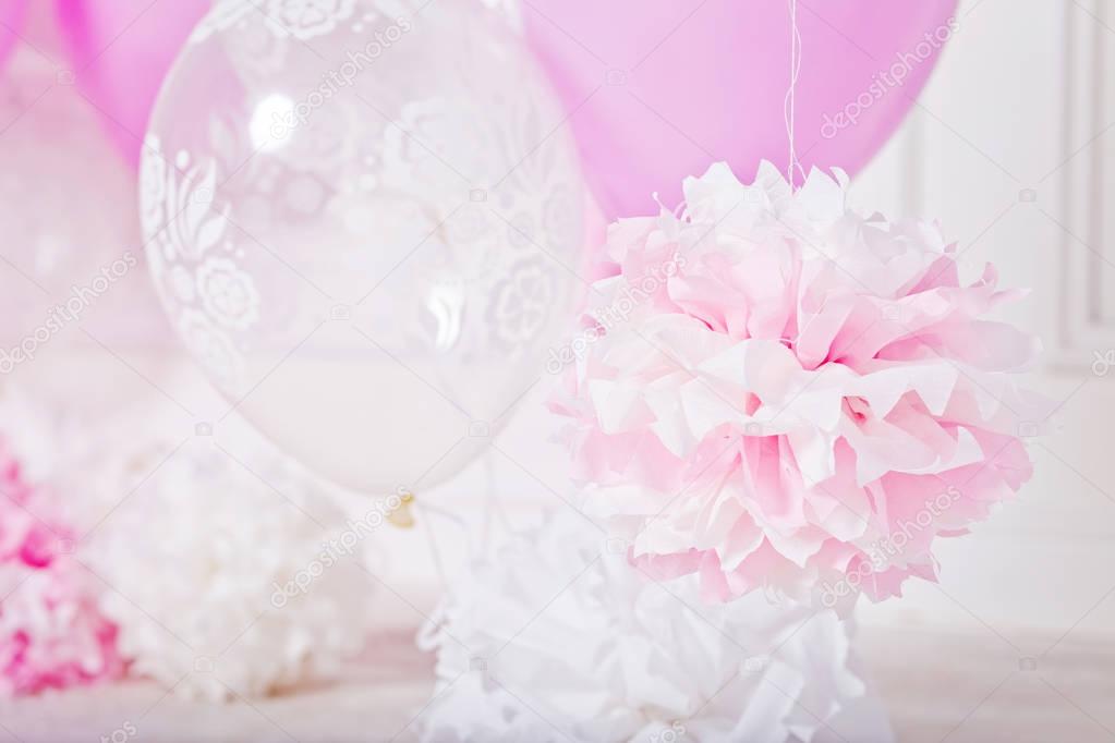 Pompoms and ballons for a party. Pink and white colors 