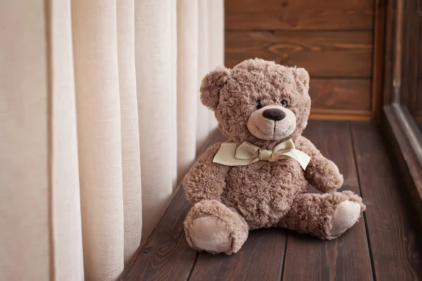 Teddy Bear juguete se sienta en un alféizar de ventana de madera — Foto de Stock