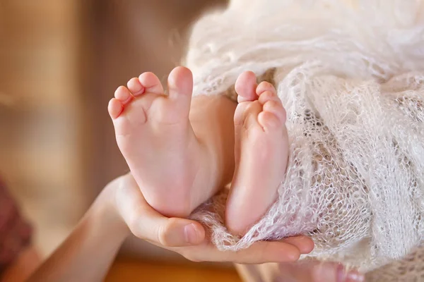 Pies de bebé en manos de madre. Mamá y su hijo. Conce familia feliz — Foto de Stock